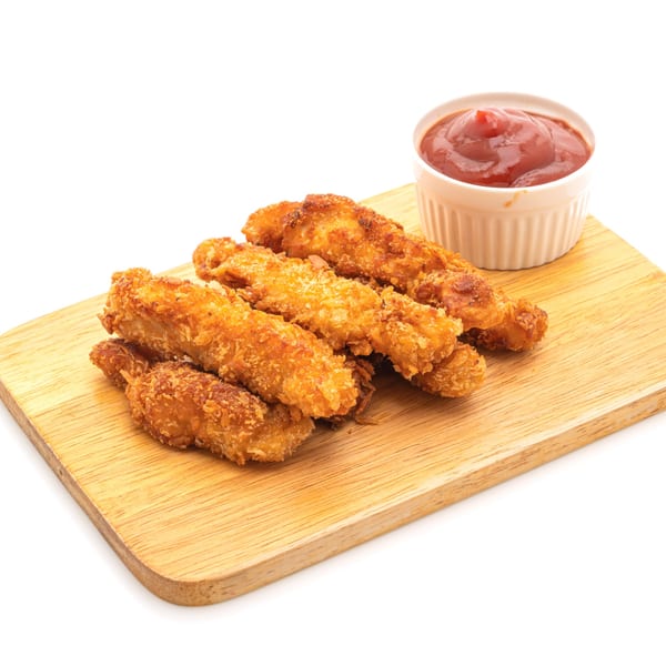 Crispy fried chicken tenders with a side of Bama Boys BBQ sauce on a wooden board.